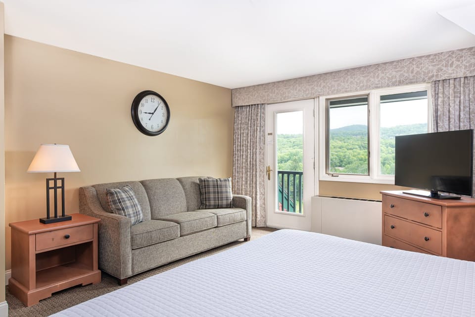 Comfortable living area with a plush sofa and ample natural light, providing a welcoming space to relax and unwind.