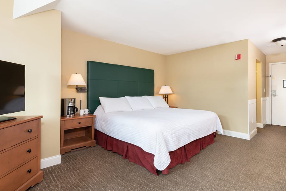 Peaceful bedroom with a warm and inviting ambiance, ideal for relaxation and rejuvenation during your stay.
