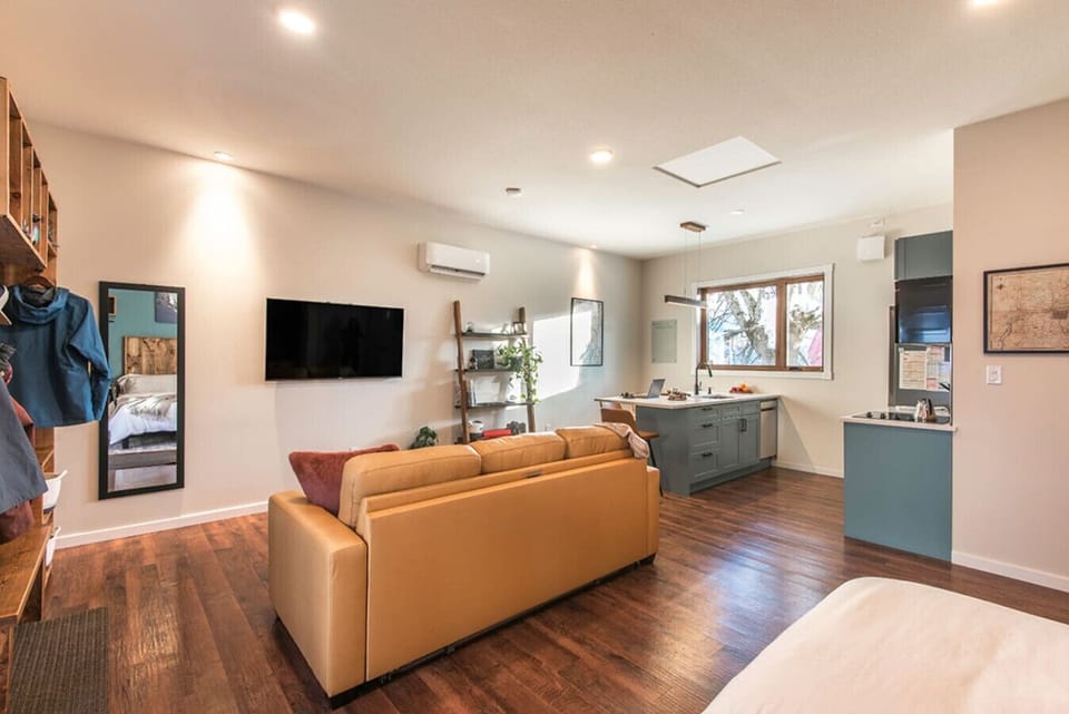 Comfy and spacious open-concept living area and kitchen, including cozy king-sized bed and queen-sized pullout couch.  Large kitchen island with seating for four in the fully stocked kitchen.