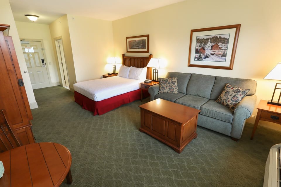 Cozy room with a plush bed and additional seating area, offering plenty of space to unwind.