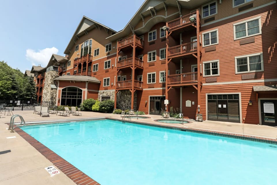 Refreshing outdoor pool surrounded by mountain charm, perfect for a relaxing dip after a day of adventure.