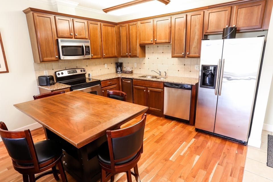 Fully equipped kitchen with modern appliances and a dining area for enjoying home-cooked meals.