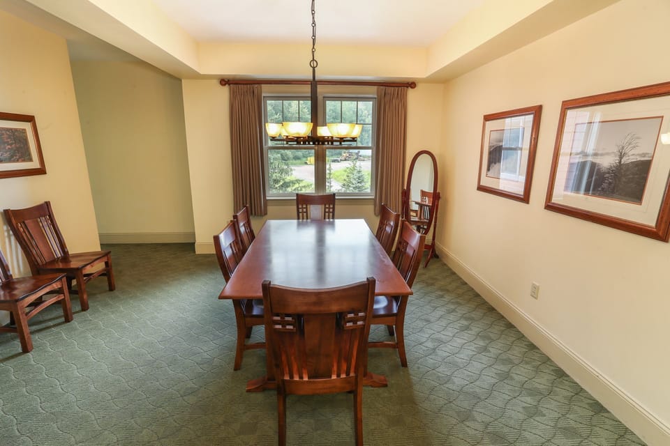 Dining area with a large table, perfect for enjoying meals or game nights with friends and family.