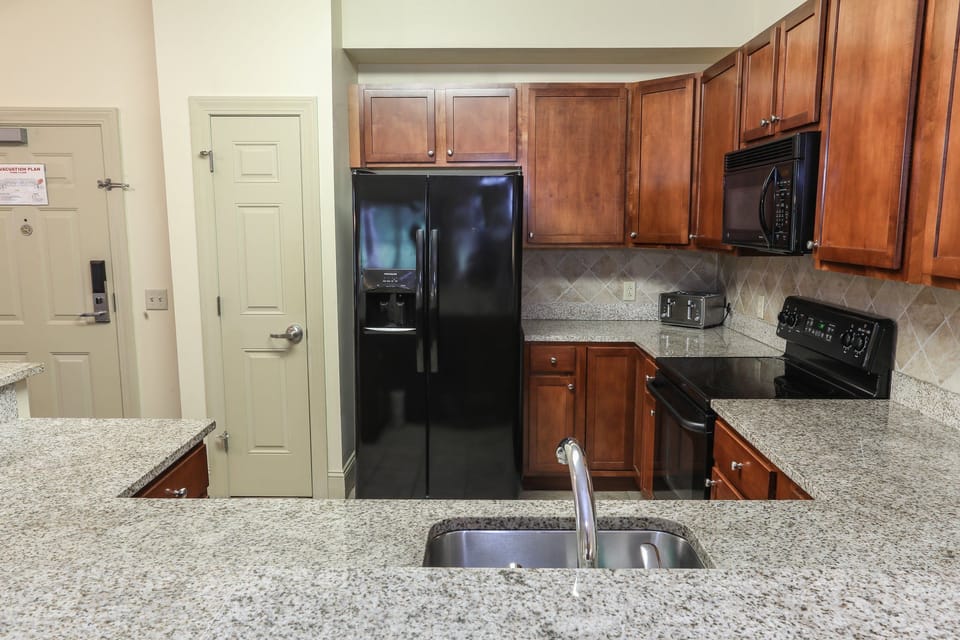 Modern kitchen with granite countertops and stainless steel appliances for easy meal preparation.