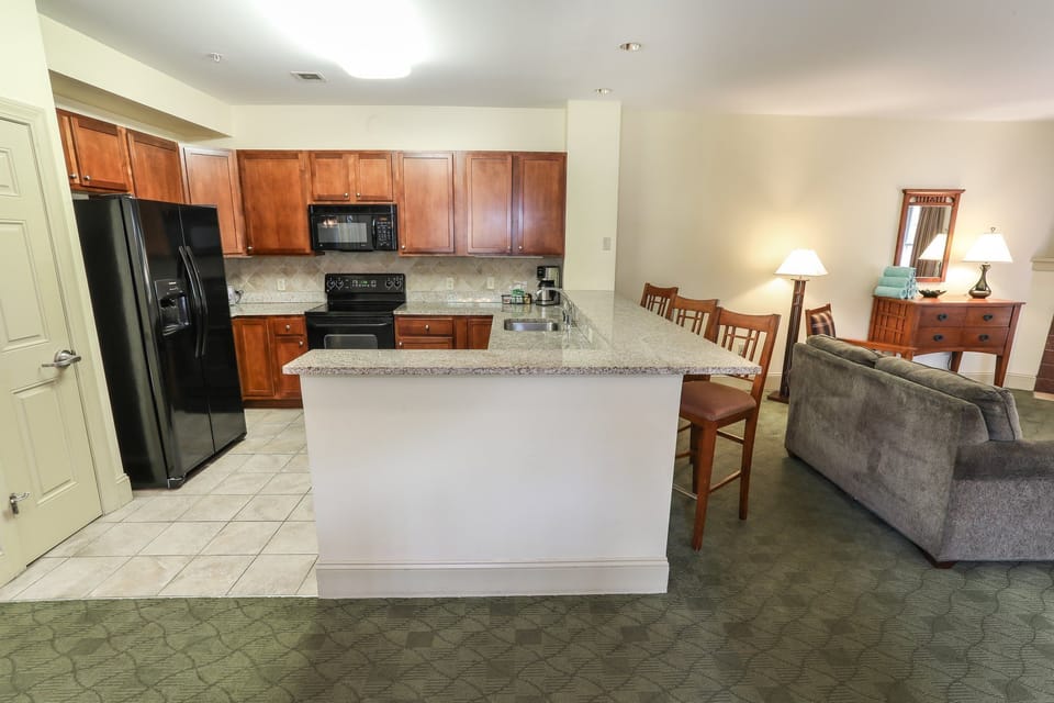 Fully equipped kitchen with a large island and adjacent dining area for enjoying home-cooked meals.
