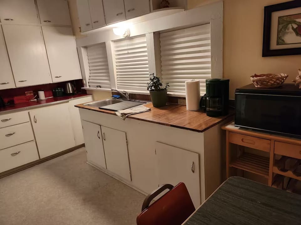 Kitchen with small range, microwave, toaster, coffee maker