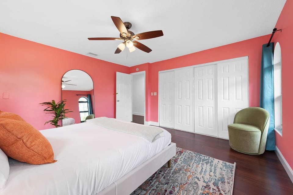 Master's bedroom with standing mirror, wardrobe, and ceiling fan