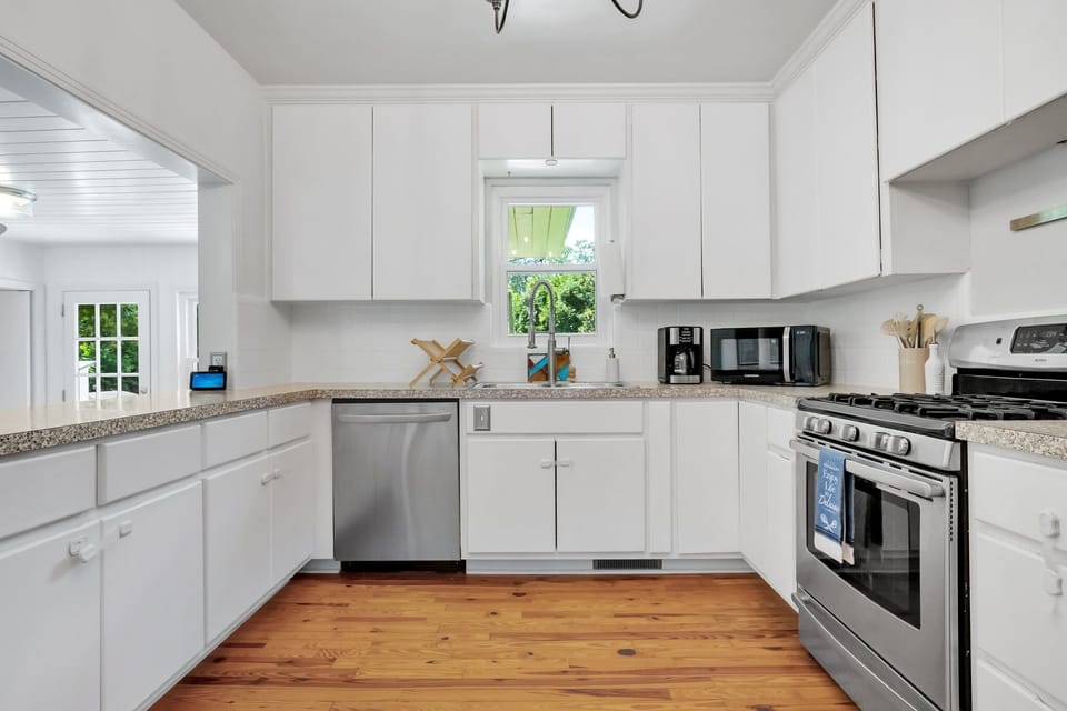 Roomy kitchen with plenty of kitchenware and utensils
