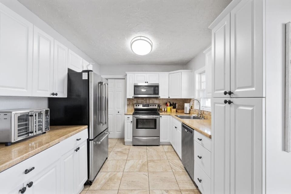 Spacious kitchen with updated appliances and pantry. Kitchenware included