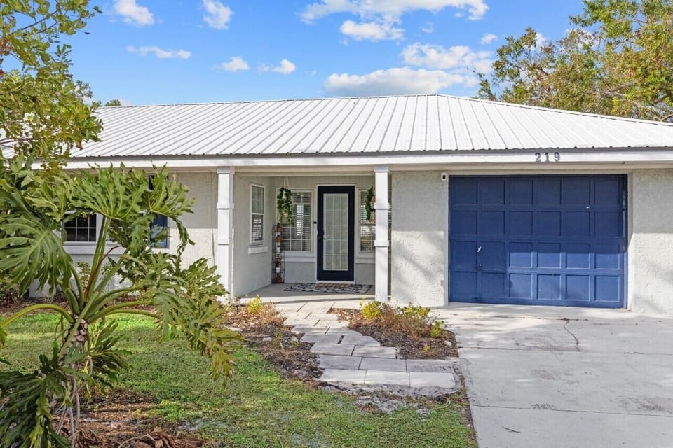 Charming blue front door with keycode entry for easy access.