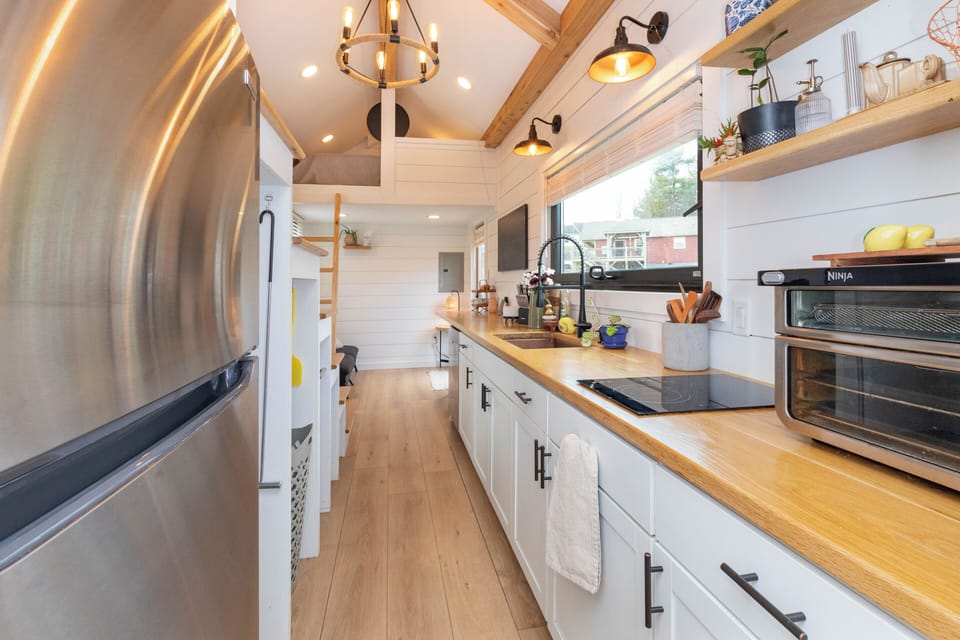 Full height fridge with under stair nook storage. 