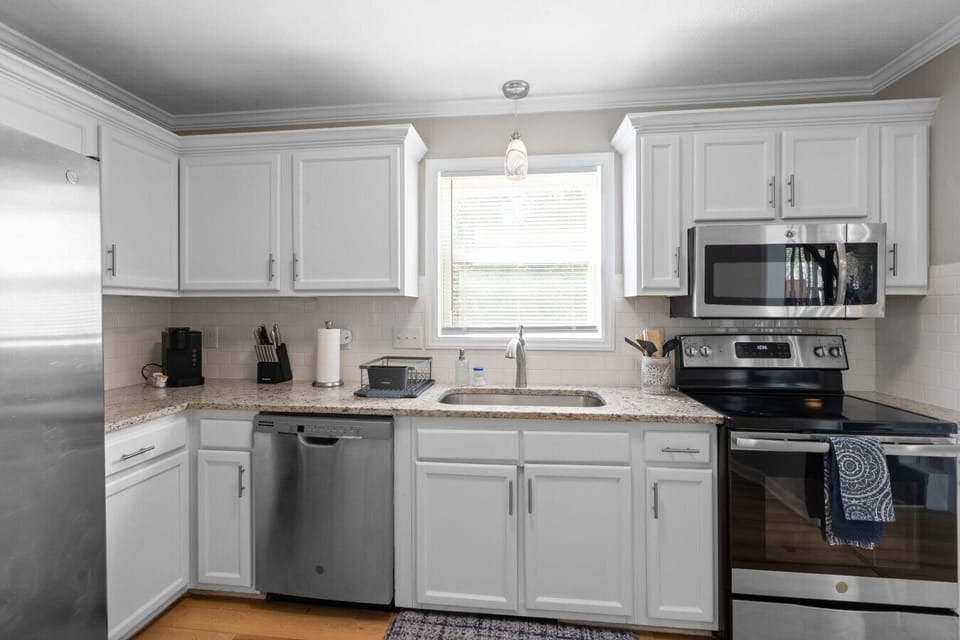 Bright kitchen with stainless steel appliances, granite countertops, and plenty of cabinet space