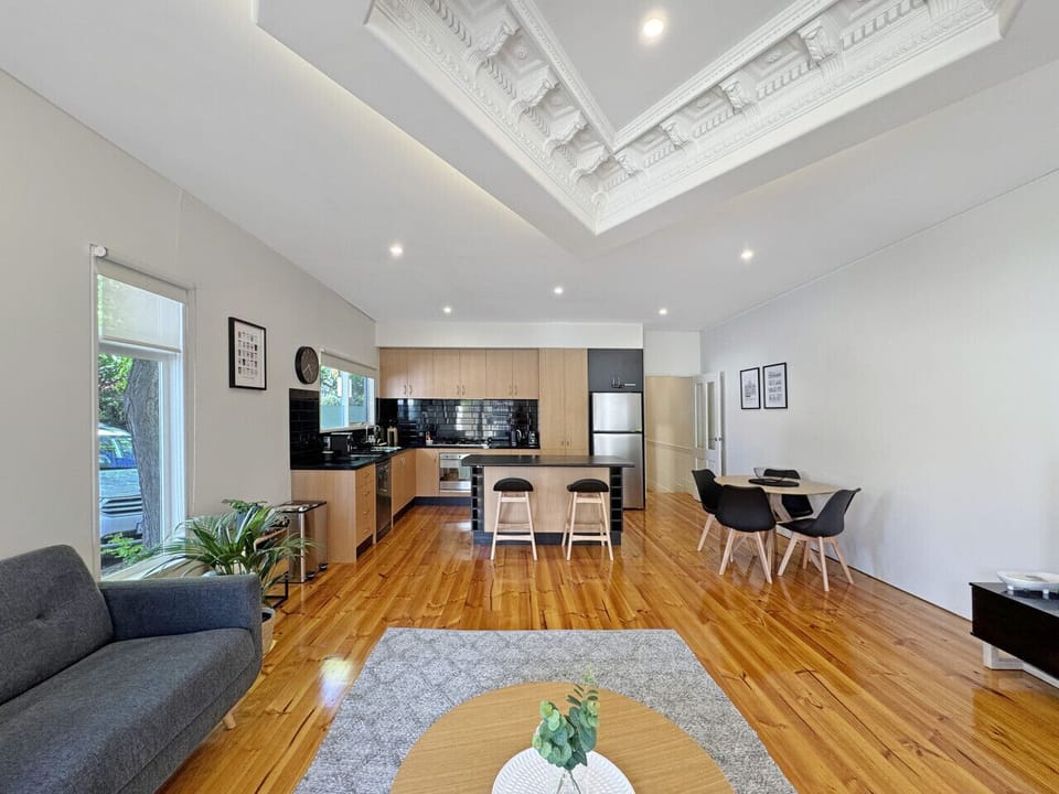 This warm and welcoming space blends modern comfort with classic design elements, offering room to cook, dine, and relax.