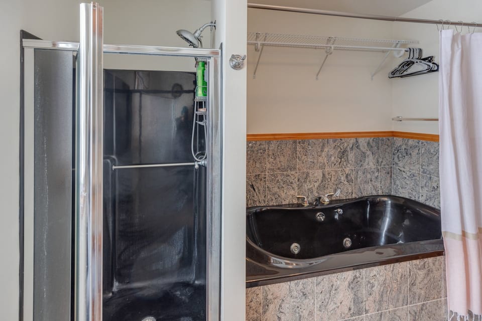 Main Level King Bedroom Ensuite Bath boasts granite countertops and both a shower and jetted tub.