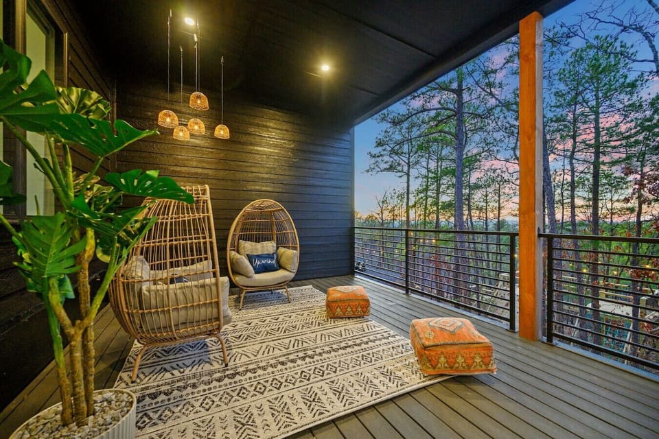 This twilight deck is basically made for those golden-hour moments when you want to kick back in a cozy hanging chair, soak in the forest views, and let those pendant lights set the perfect vibe as the sun dips below the treeline.