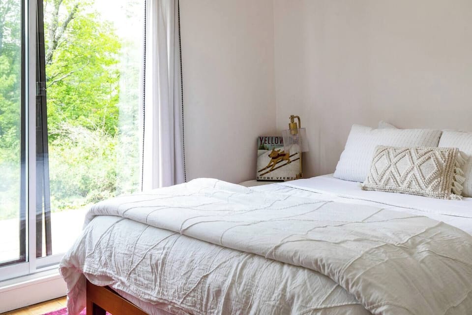 Views from bed of the natural setting over the pond with hills beyond.