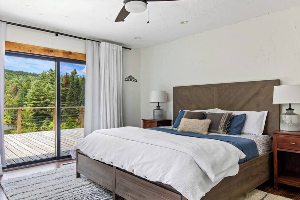 Master bedroom with sliding door out to the deck overlooking the Trapp hills and pond.