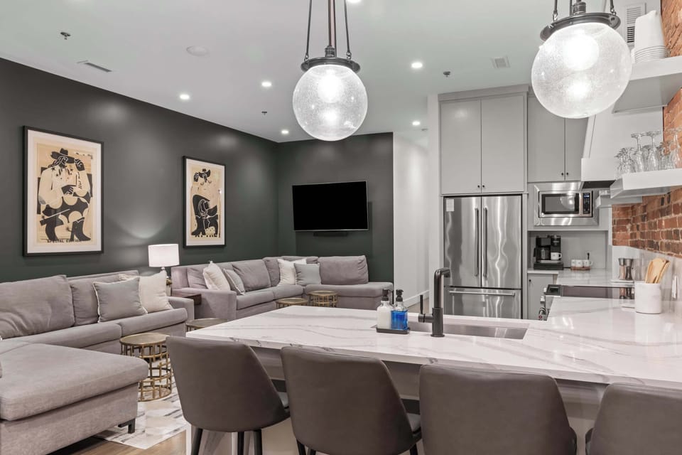 Bright and spacious kitchen with white cabinetry, open shelving, and a long island that seats four. Perfectly designed for cooking, hosting, and gathering.