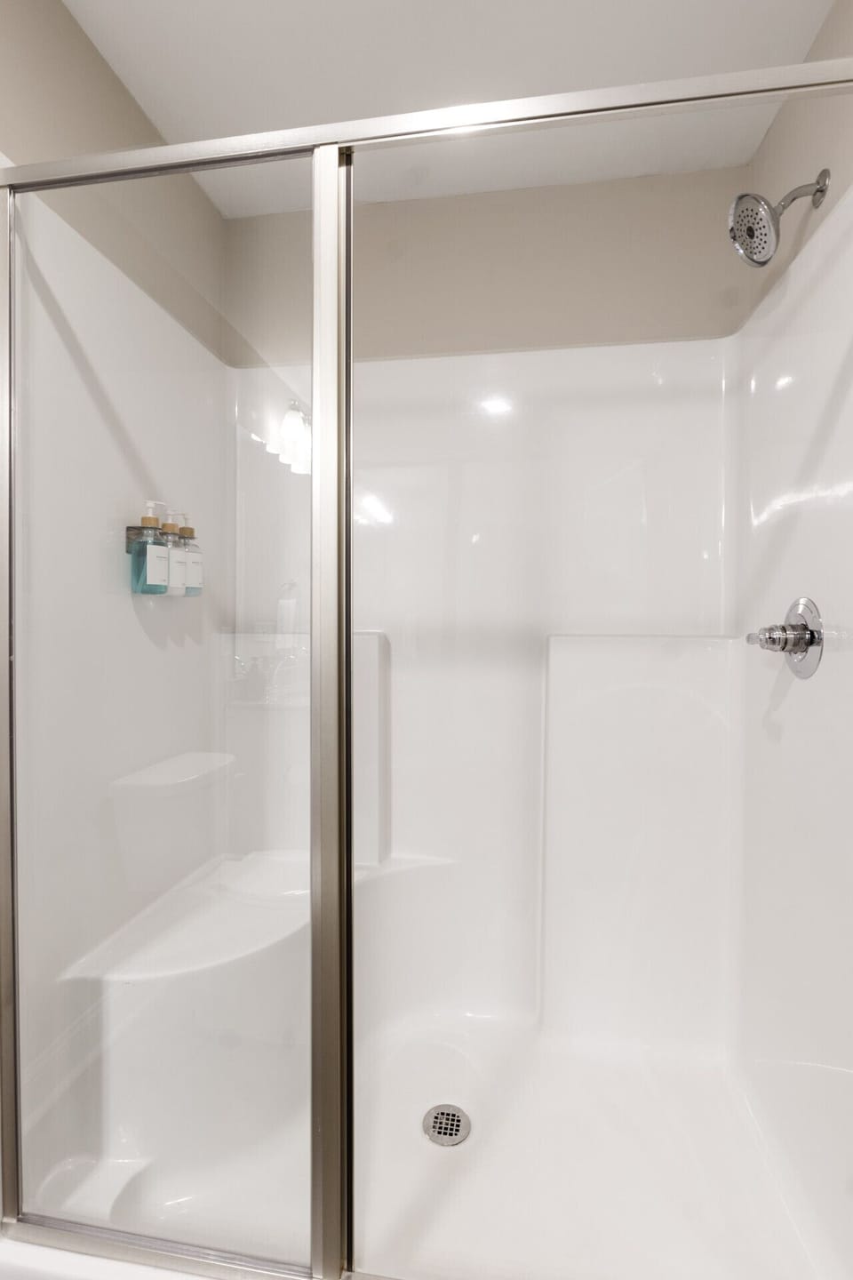 Clean and stylish walk-in shower with fresh amenities for a refreshing start to your day.