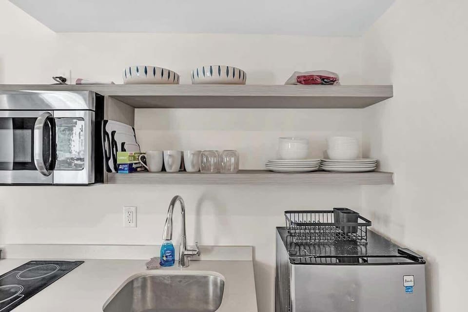 Open kitchen shelves with dishes and appliances