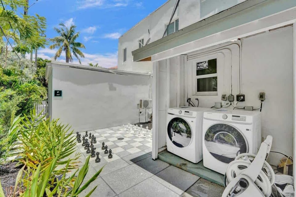 Outdoor laundry area with full-size washer and dryer
