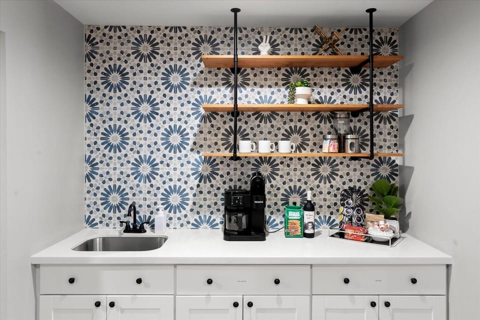 From cocktails to coffee, this wet bar area and coffee station have everything you need to unwind and refresh.
