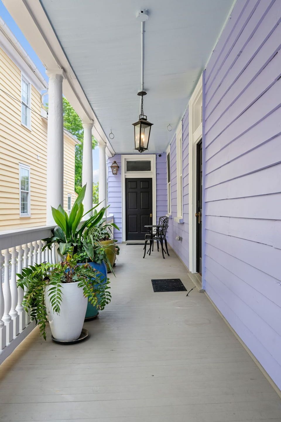 Welcoming porch with classic charm and greenery.
