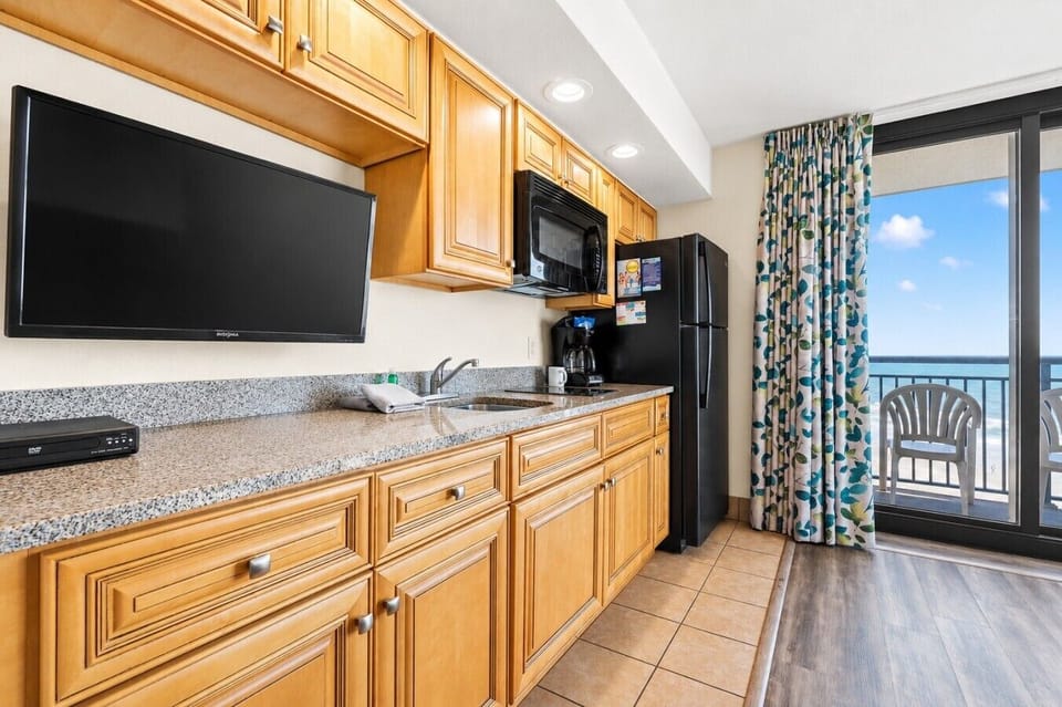 BC625 - KitchenCook with an oceanfront view in this fully equipped kitchen, featuring stovetop burners, a refrigerator, microwave, toaster, drip coffee maker, sink, dishware, silverware, and cookware. Enjoy the view while preparing meals in this coastal s