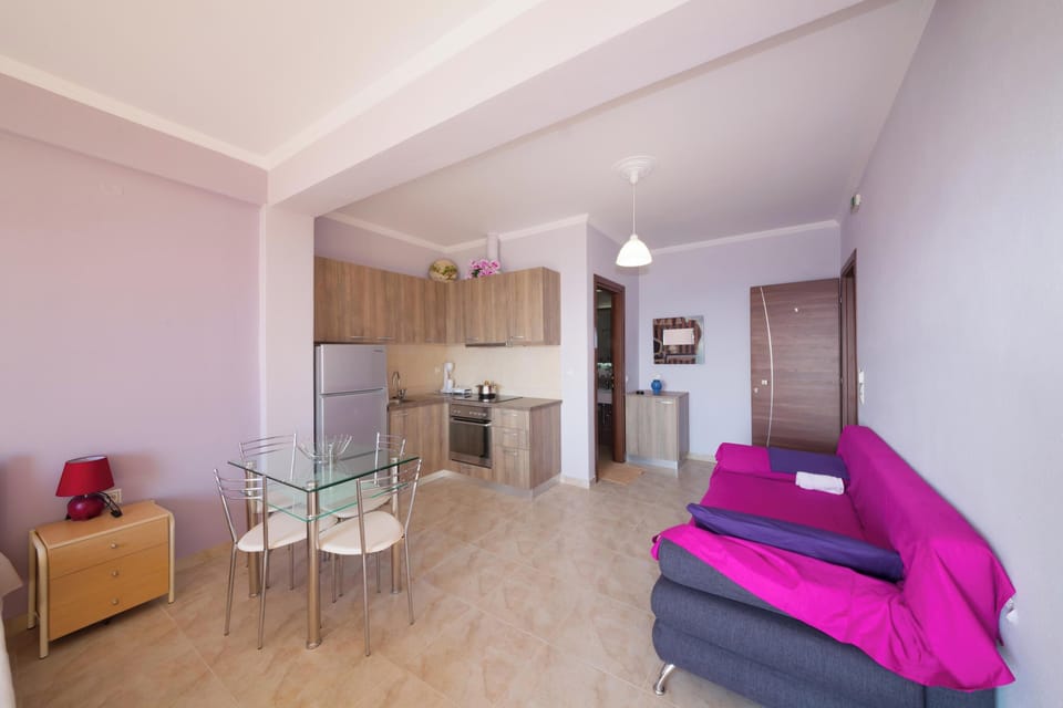 Spacious Open-Plan Layout with Sofa, Dining Area, and Clean Tile Flooring

