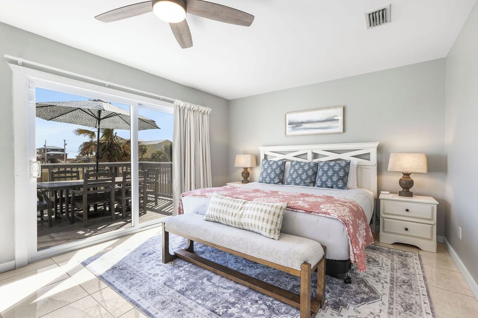 Bedroom 1, King ensuite. Features patio slider, blackout curtains & smart TV