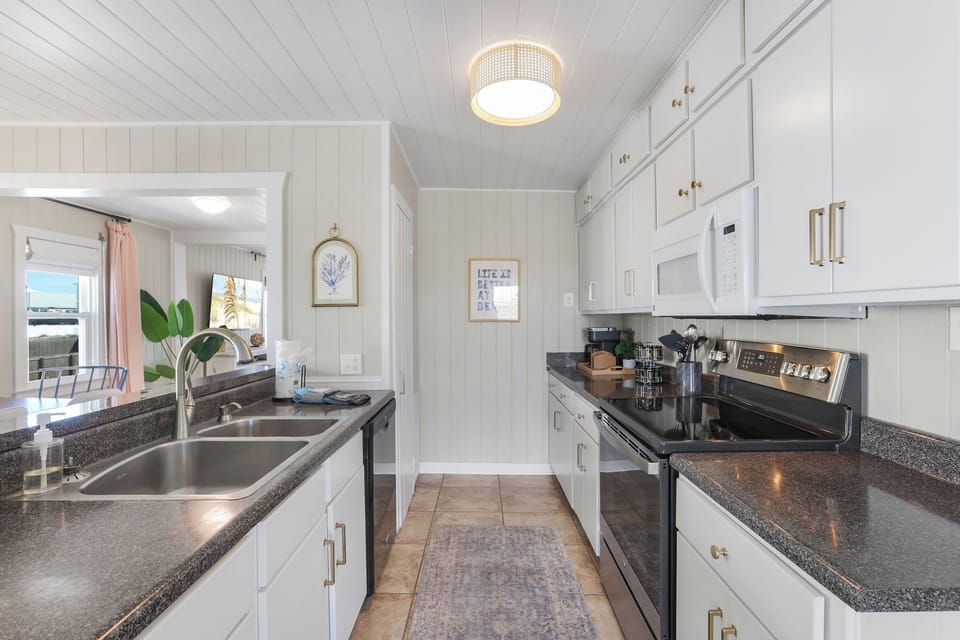 Fully stocked kitchen overlooks dining room