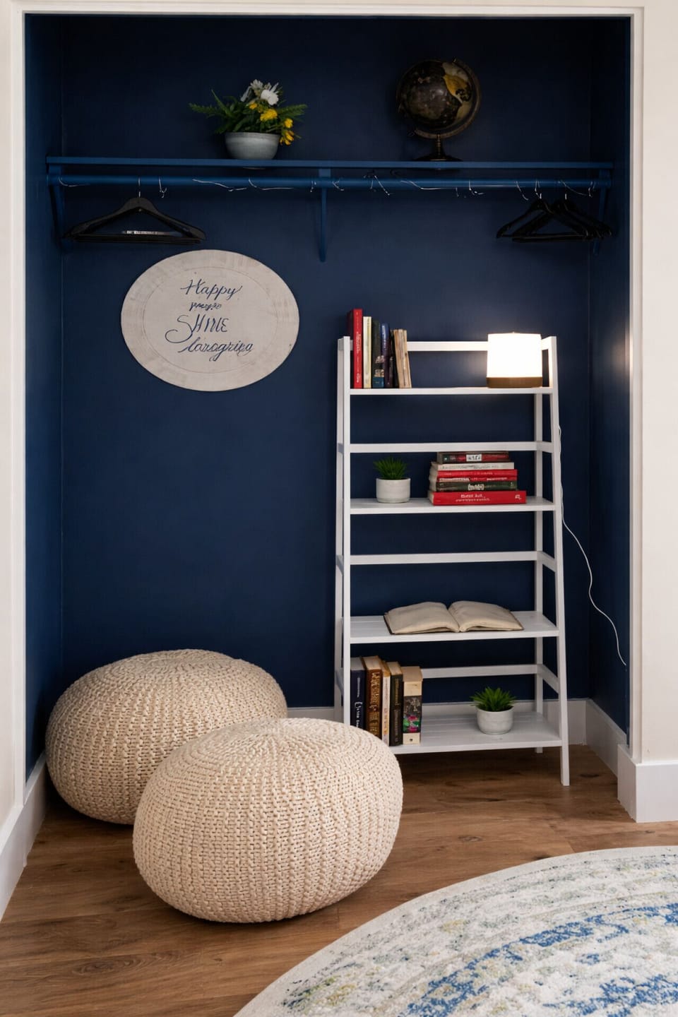 Cozy reading nook with navy accent wall and bookshelf.