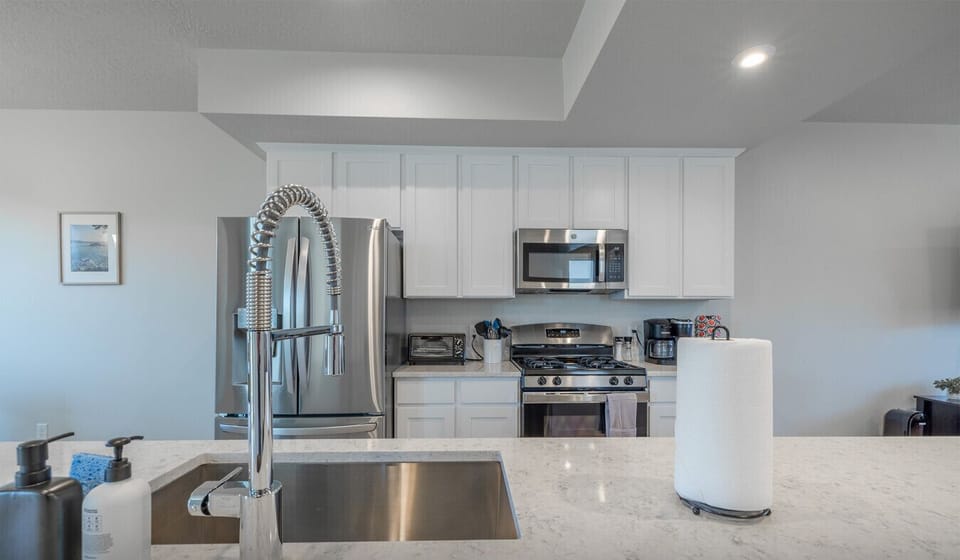 Contemporary kitchen with stainless steel finishes and spacious counters.