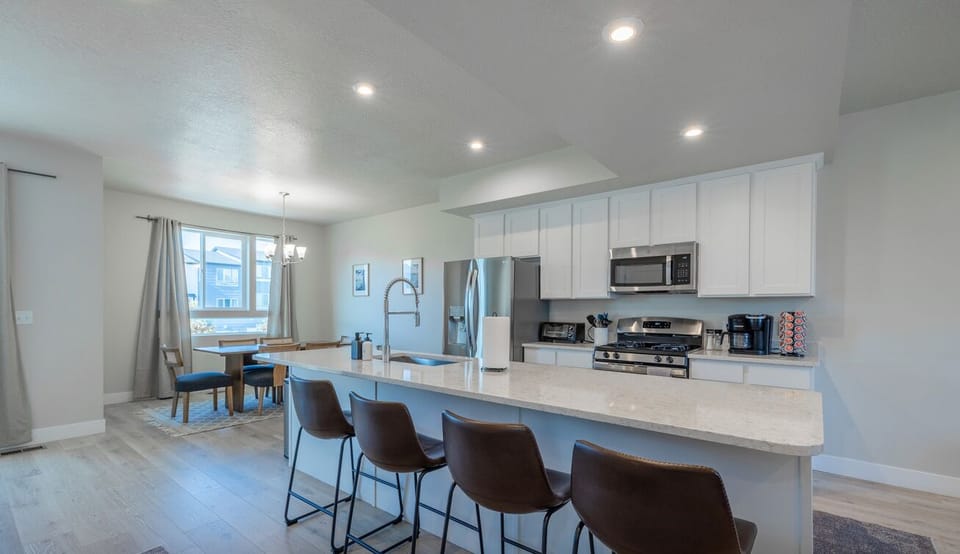 Fully equipped kitchen with sleek finishes and bar seating for shared meals.