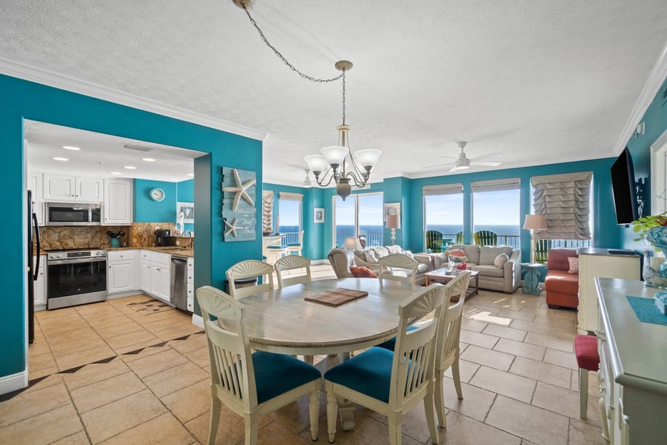 Open living and dining area with ocean views and coastal decor.