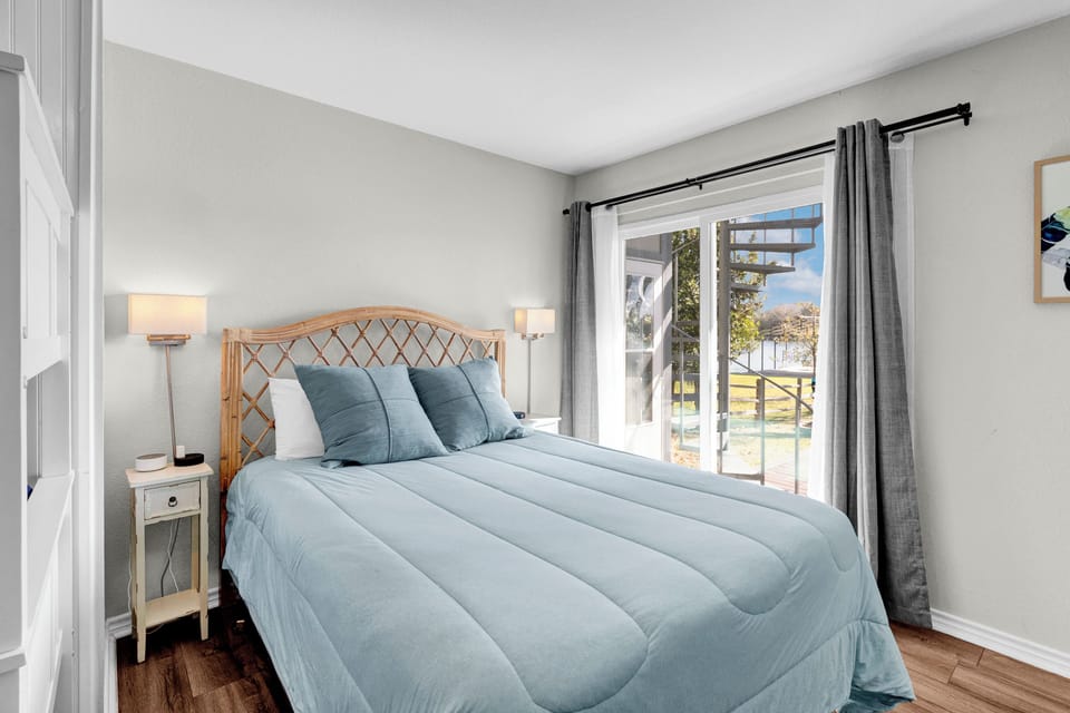 Downstairs bedroom with queen bed and twin bunks