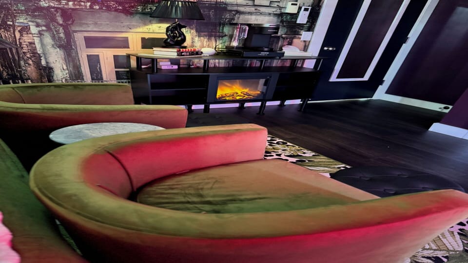 Relax in the primary suite with fireplace, coffee, and soft glow