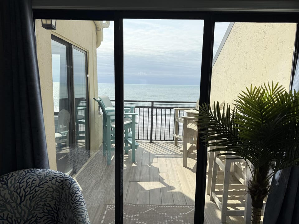 Sunlit balcony with ocean views, perfect for morning coffee