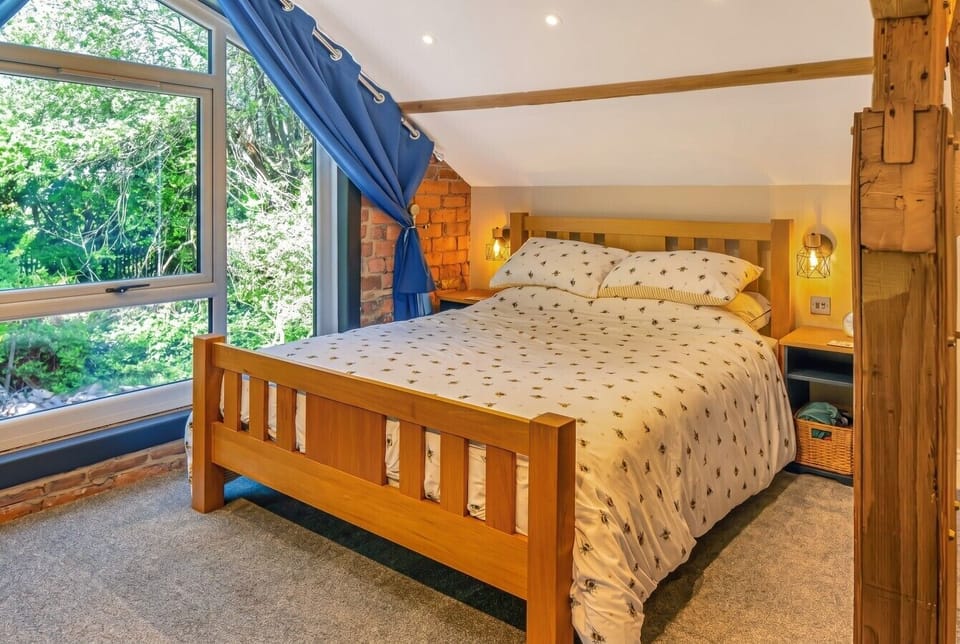 Wake up to floor-to-ceiling greenery through the feature window in the double bedroom.