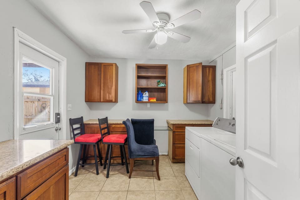 Laundry room with extra chairs and storage