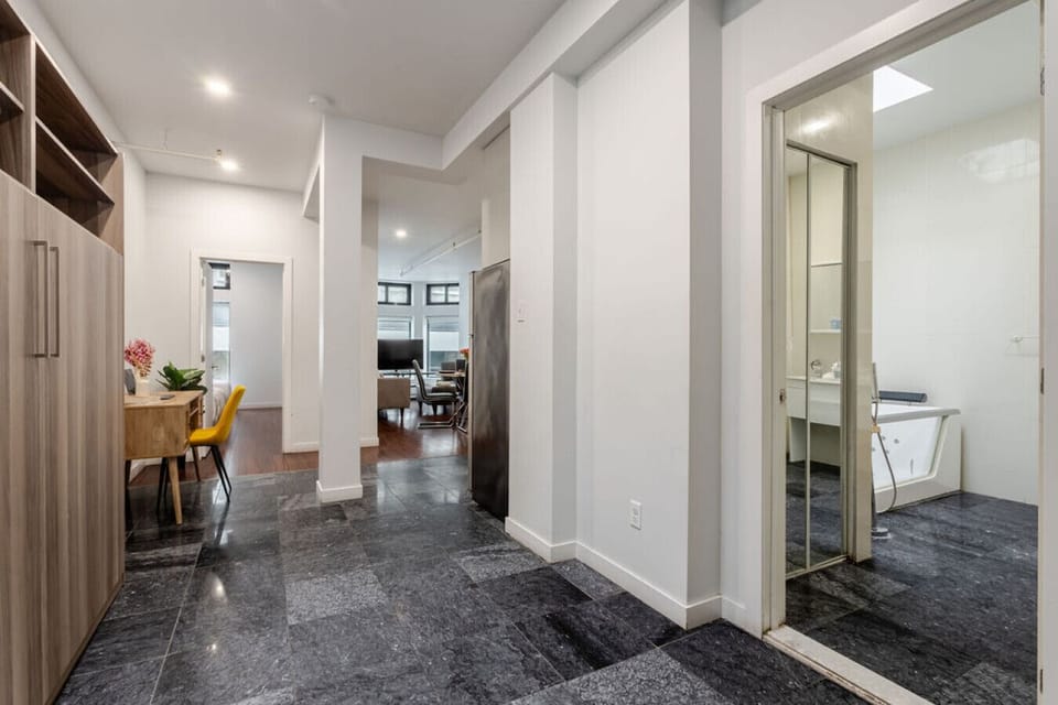 Clean and open layout with modern flooring and seamless flow between spaces