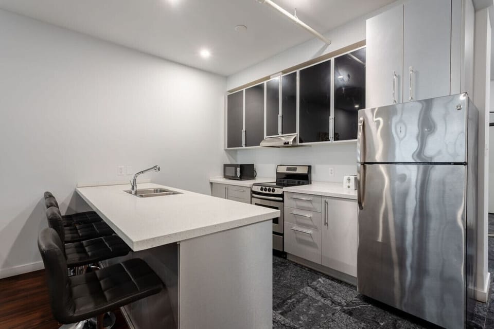 Modern kitchen with sleek cabinetry, stainless steel appliances, and a spacious island for casual dining or meal prep