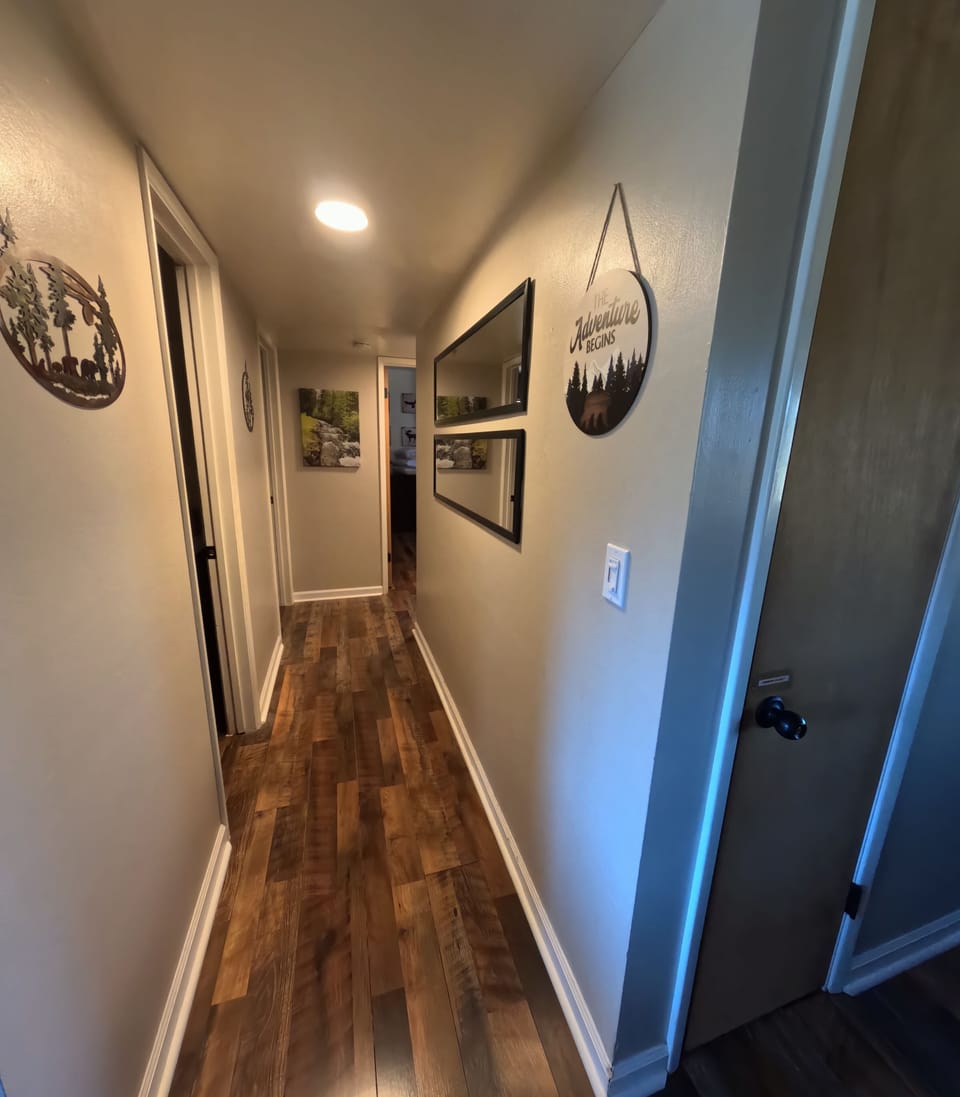 Warm hallway connecting bedrooms and main bathroom.