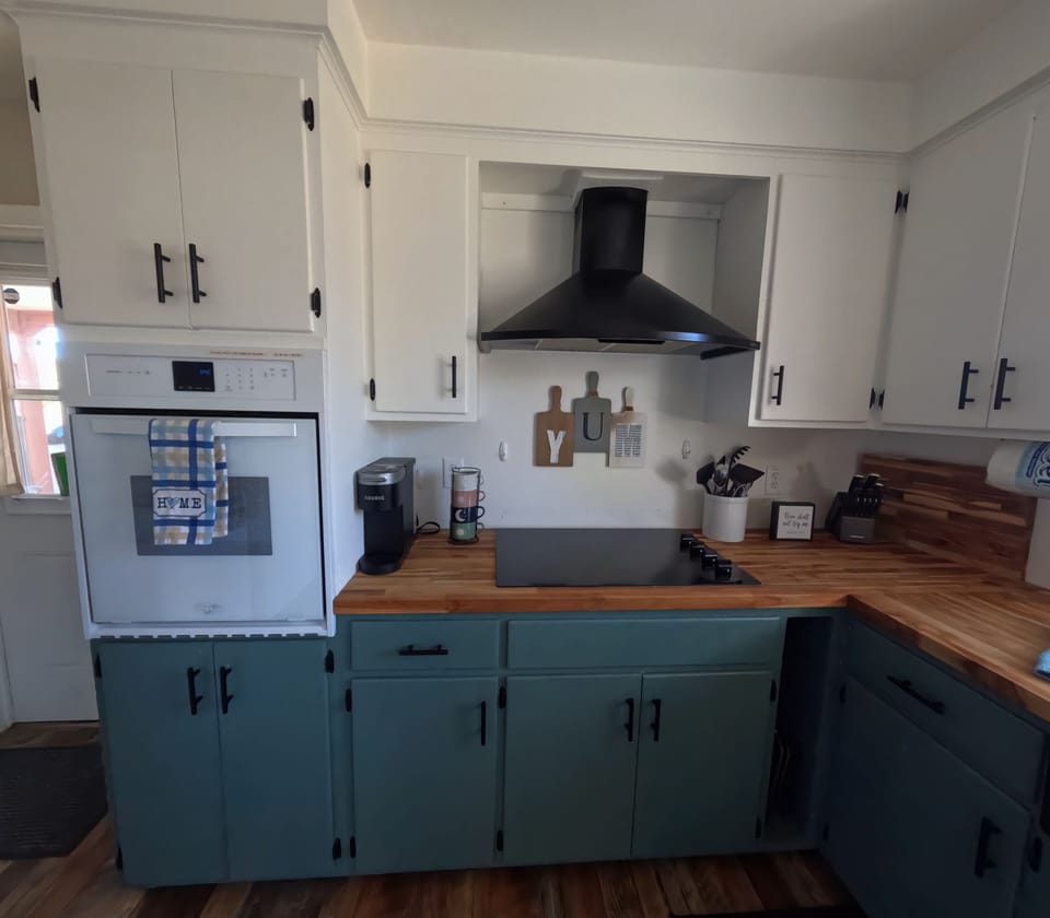 Cabin kitchen with coffee station and warm wood accents.