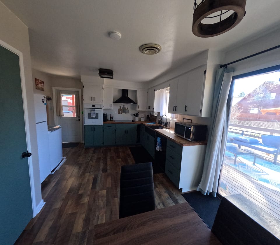 Bright, fully equipped kitchen with deck access.