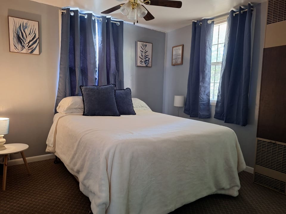 This bedroom has a queen sized bed. No door, just curtains separating it from the kitchen. 
