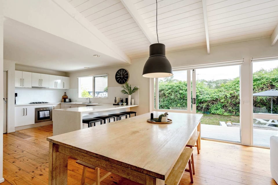 Gather around the rustic timber dining table for meals with loved ones