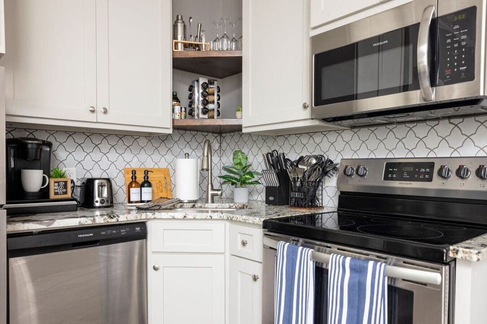 Cook, dine, and unwind in your private fully stocked kitchen featuring a stove/oven, microwave, kitchen towels, stainless steel appliances, and all the cooking essentials you need.