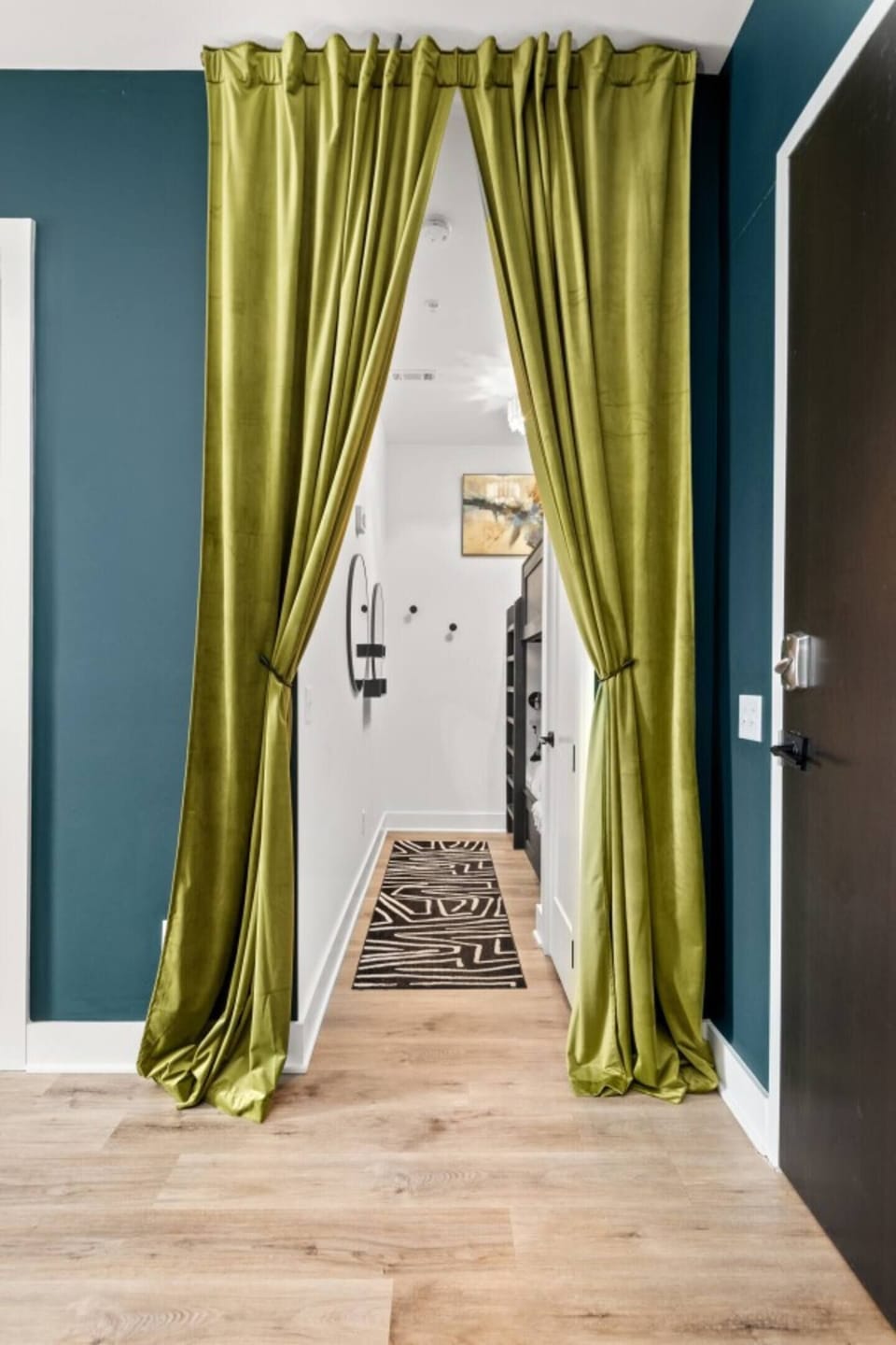 Step into style with vibrant curtains and modern decor welcoming you home!