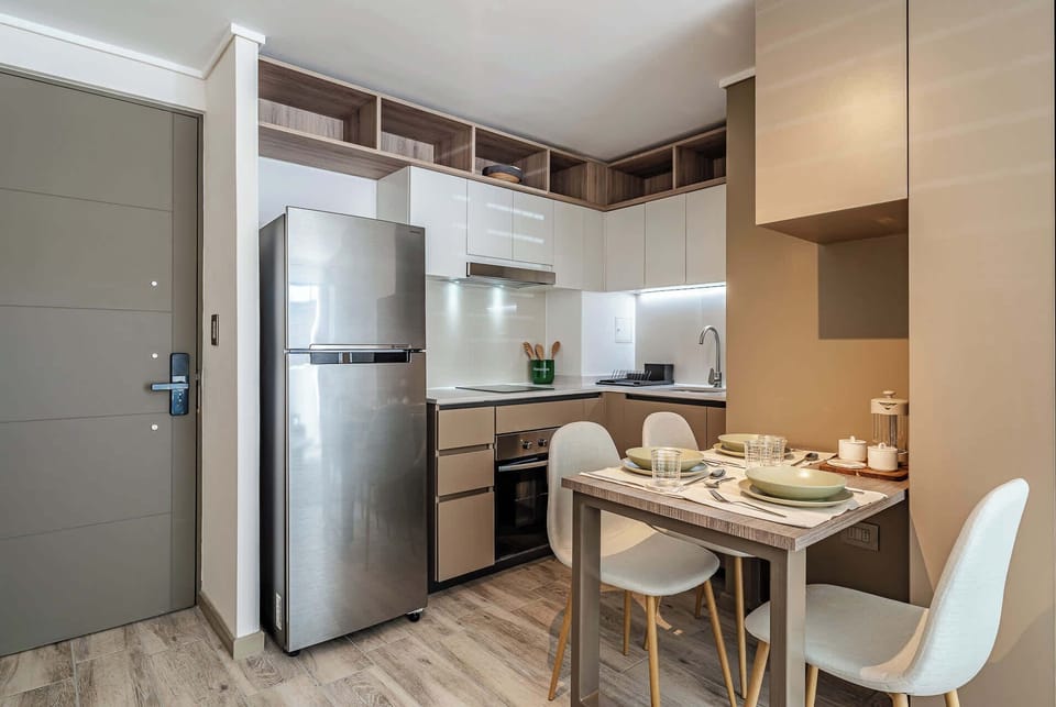 Cozy and modern kitchen with dining area, perfect for intimate meals in your private apartment studio.
